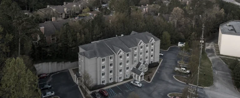 Aerial view of a hotel property surrounded by trees